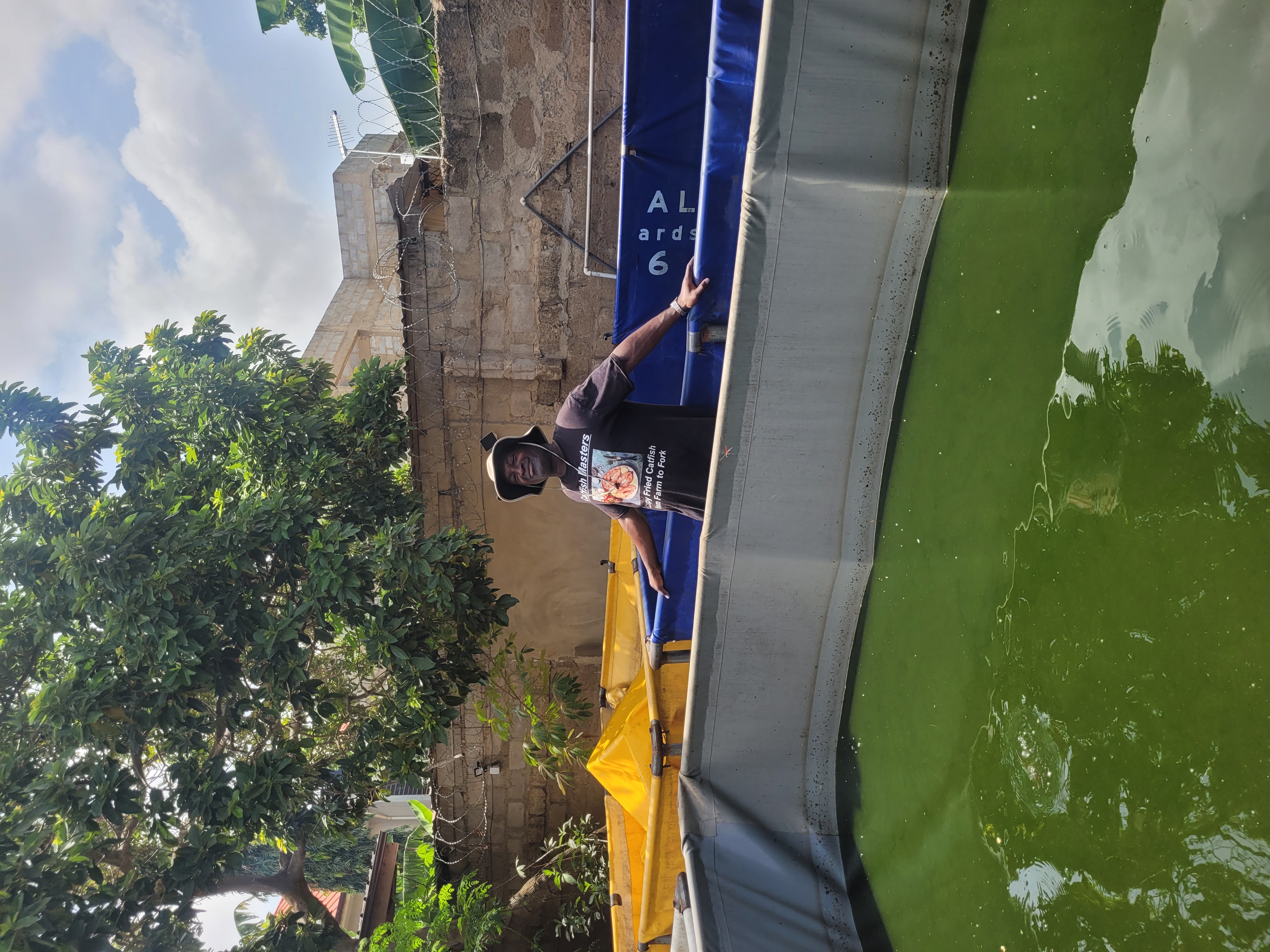 John Adjei standing at the catfish ponds